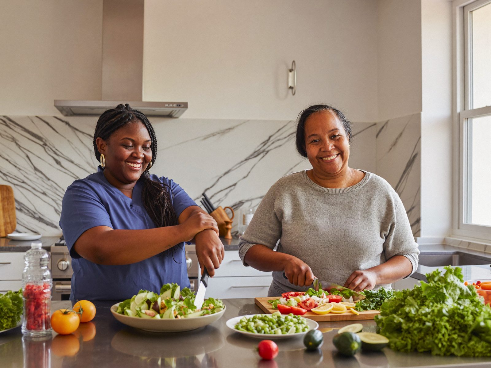A Divine Care support worker and client planning the week's supports together at the kitchen table